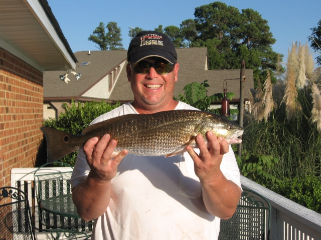 Realtor Gary Poindexter holding Red Drum caught on the Neuse River